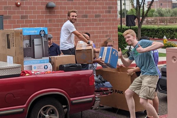 two students with truck college move in day