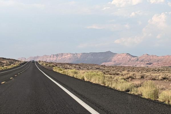 image of open road with Arizona landscape and blue sky