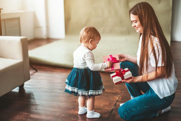 mother and child holding gift boxes