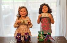 Children with owl piggy bank jars