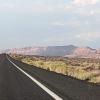 image of open road with Arizona landscape and blue sky