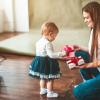 mother and child holding gift boxes