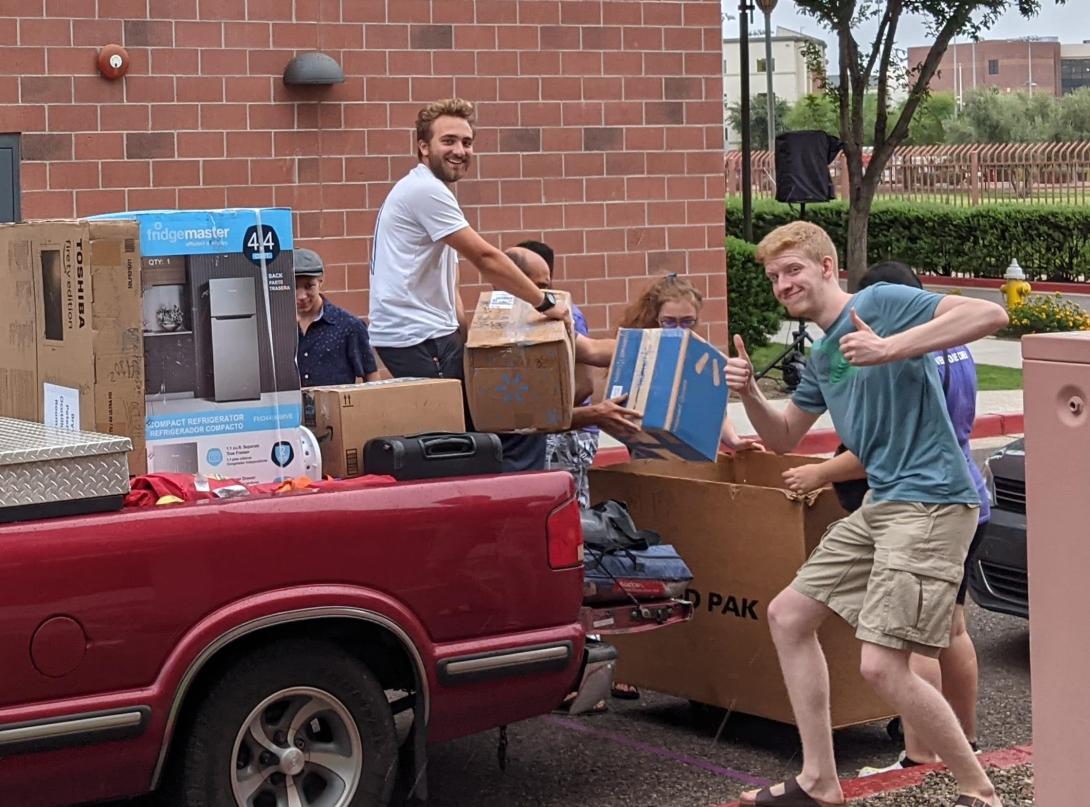 two students with truck college move in day