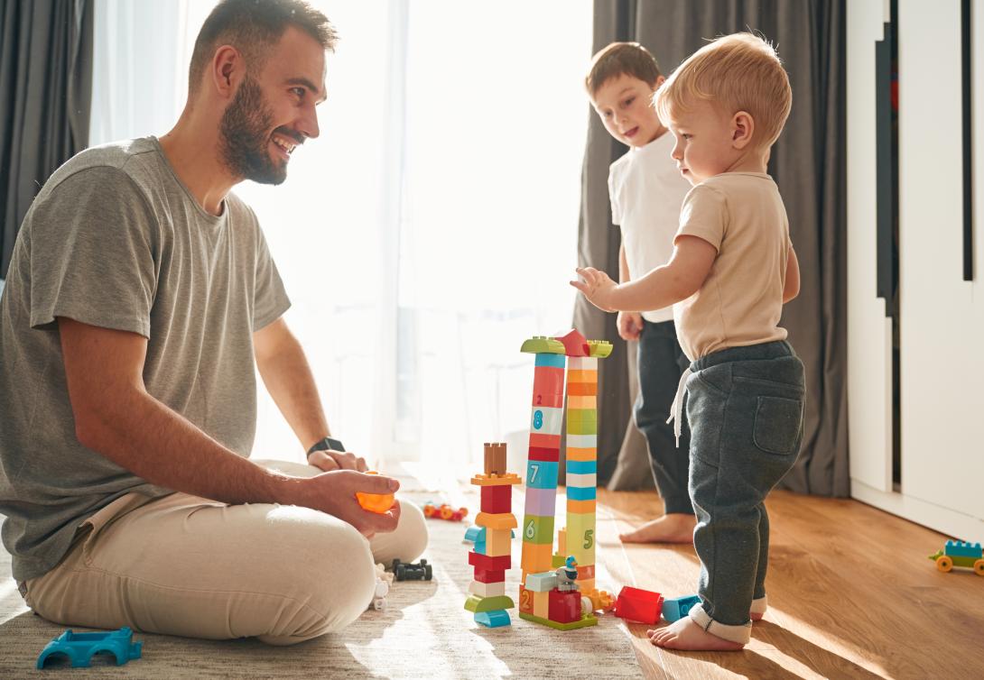 dad playing blocks with his little boys