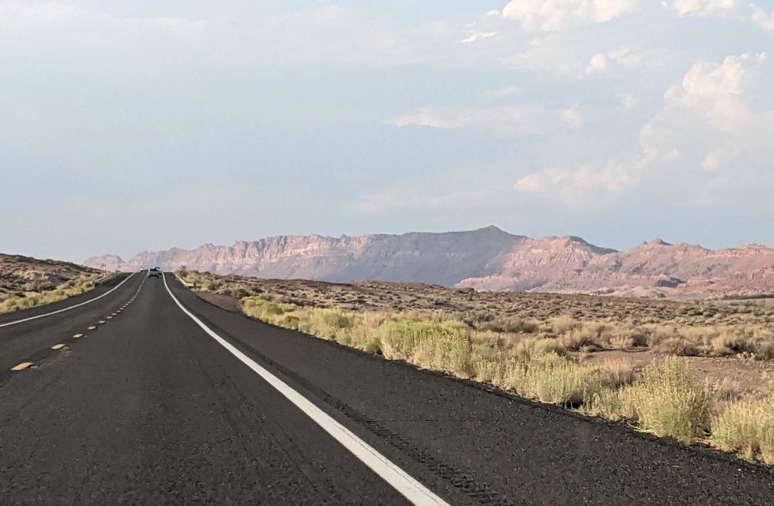 image of open road with Arizona landscape and blue sky